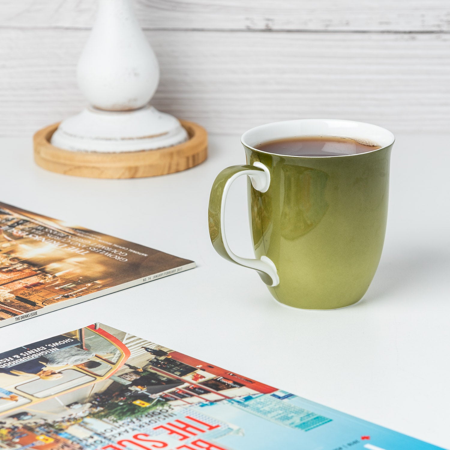Sage Green Java Mug in fine bone china, lifestyle image styled on countertop With tea