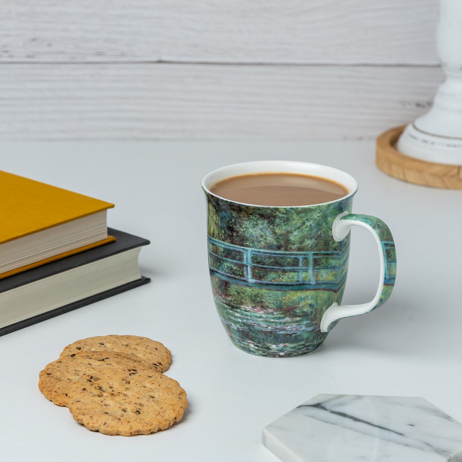 Claude Monet The Japanese Bridge Java Mug, lifestyle image styled on a countertop with latte