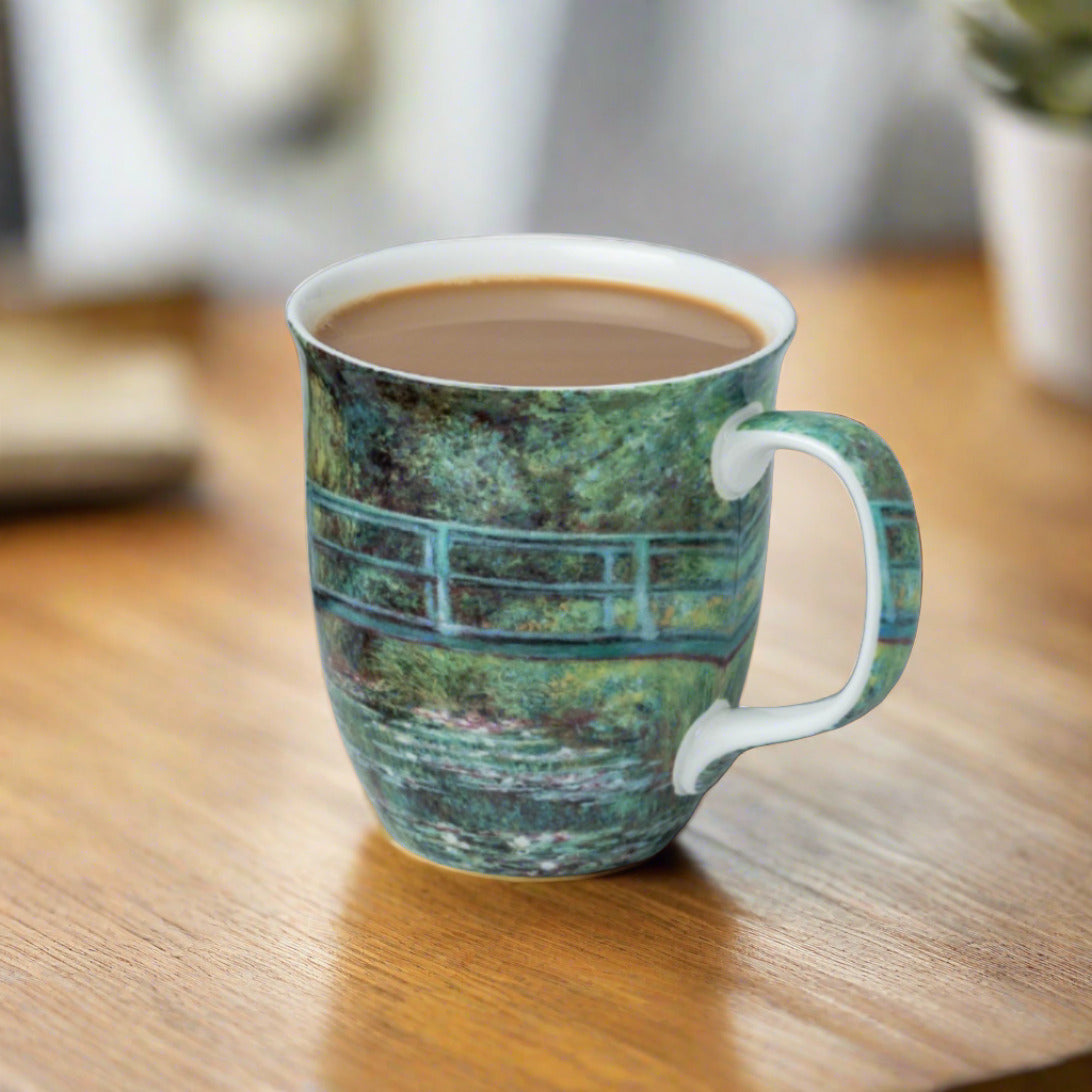 Claude Monet The Japanese Bridge Java Mug, lifestyle image styled on a dining table with coffee