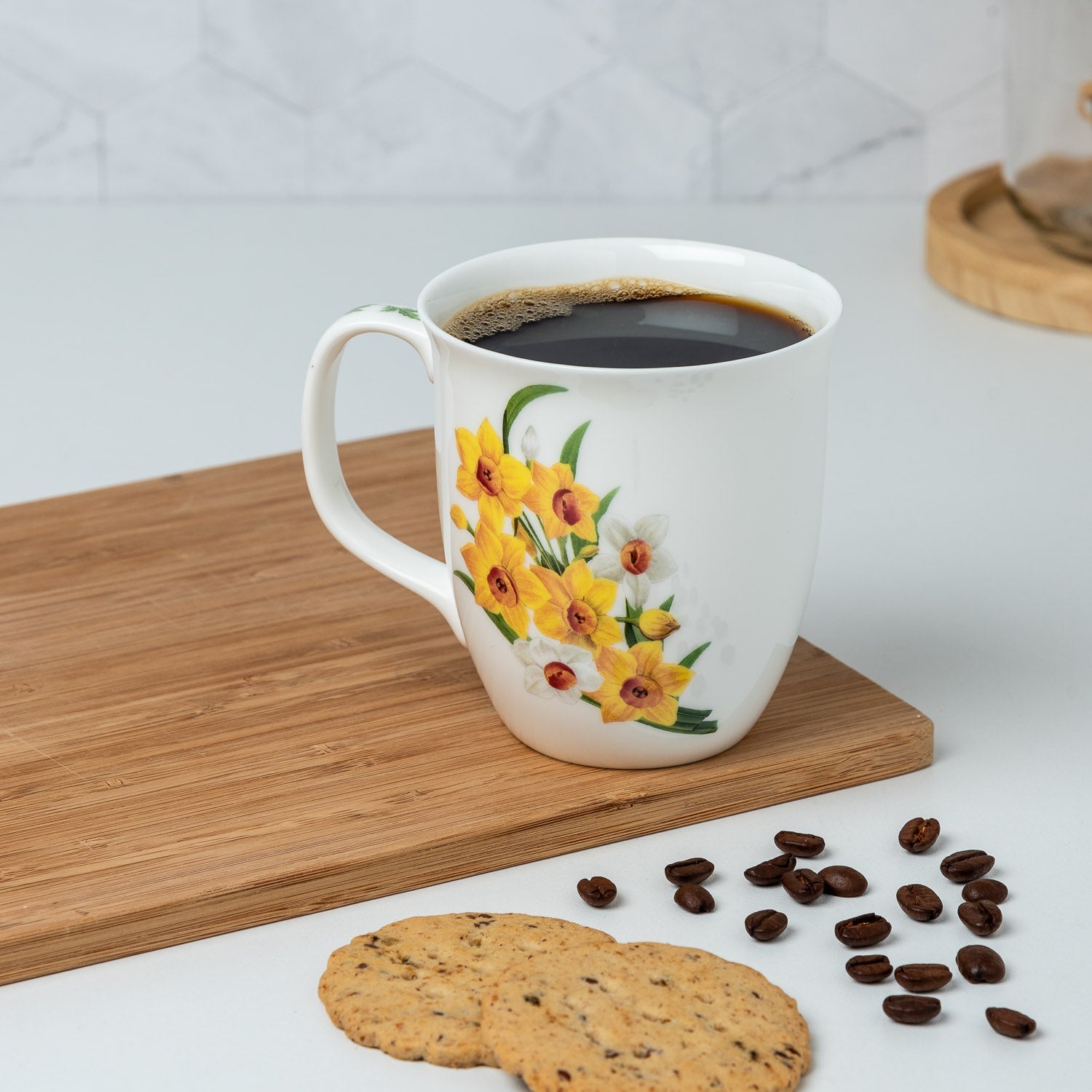 Botanical Flowers Narcissus Java Mug, lifestyle image styled on a countertop with coffee
