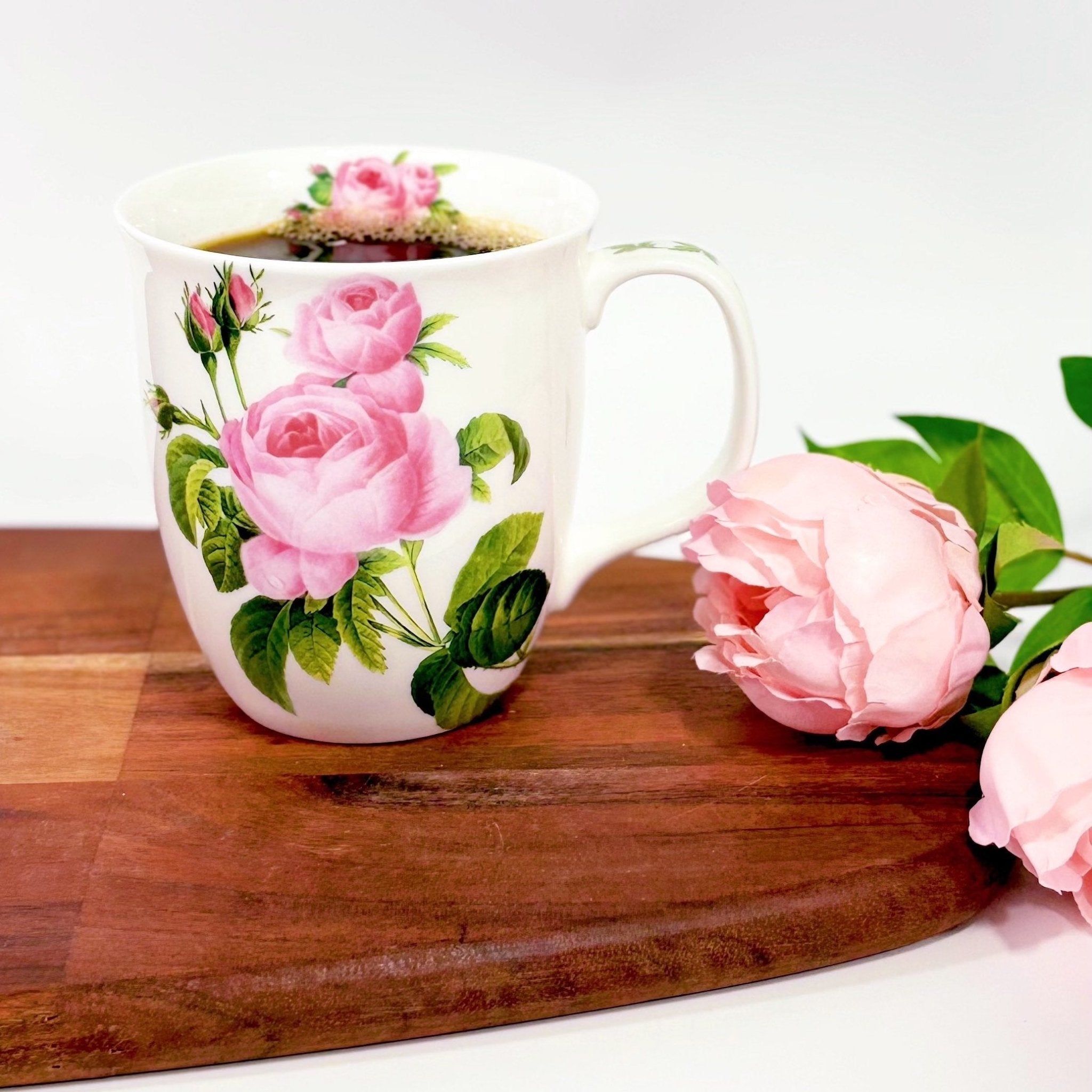 Botanical Flowers Pink Rose Java Mug, lifestyle image styled on a countertop with coffee