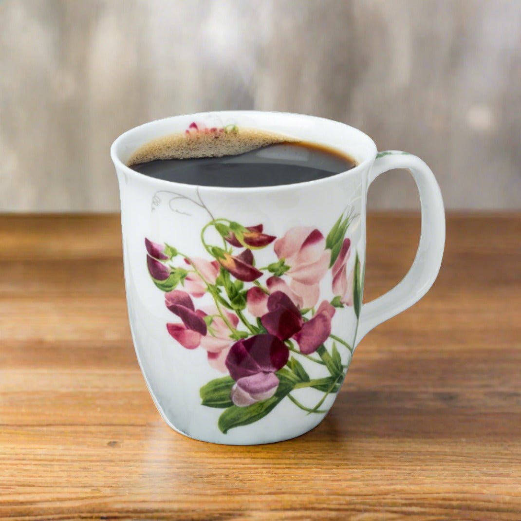 Botanical Flowers Pink Sweet Pea Java Mug lifestyle image styled on a dining table with coffee