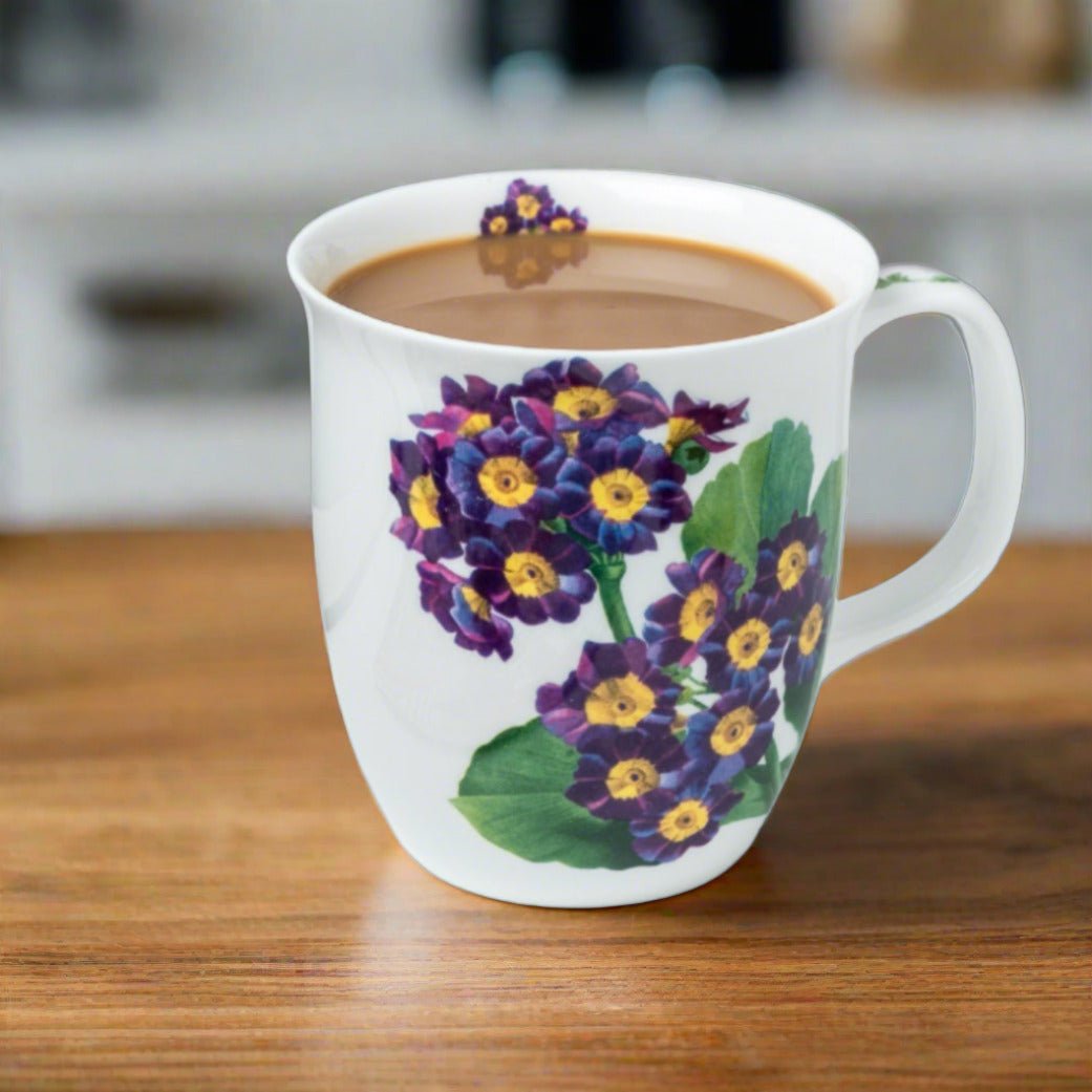 Botanical Flowers Purple Primrose Java Mug, lifestyle image styled on a dining table with cappuccino