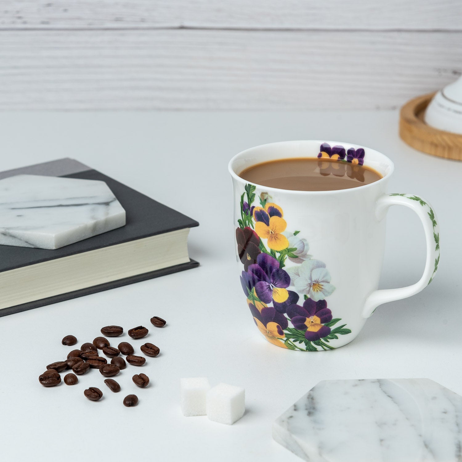 Botanical Flowers Viola Java Mug, lifestyle image styled on a countertop with coffee