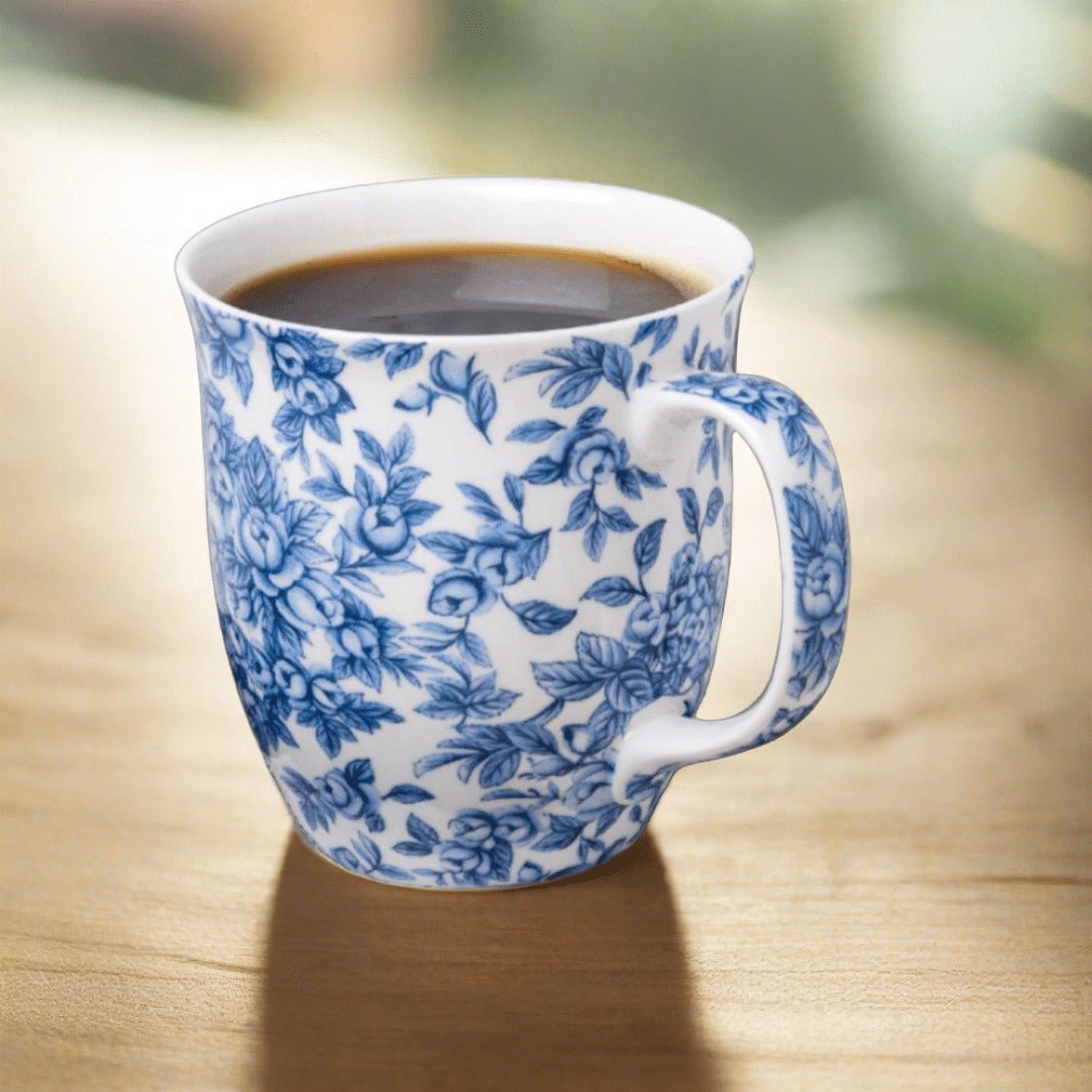 Chintz Light Blue Roses Java Mug, lifestyle image styled on a dining table with coffee