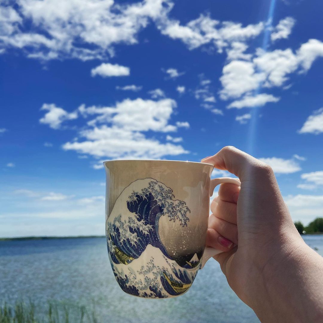 Hokusai The Great Wave Java Mug, lifestyle image styled oceanside in hand