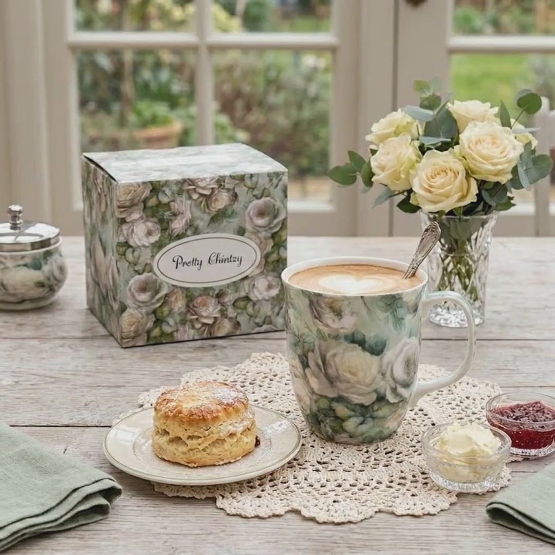 Chintz White Roses Java Mug, product video preview, styled on a breakfast table with cappuccino