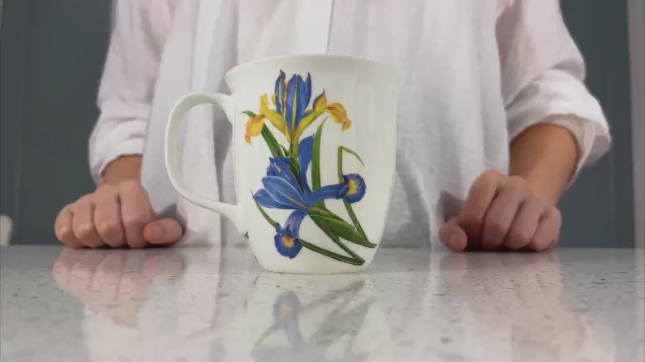 Botanical Flowers Garden Iris Java Mug, product video preview, styled on a countertop with coffee