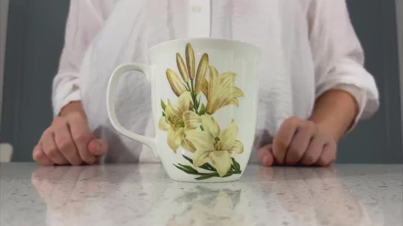 Botanical Flowers Lily Java Mug, product video preview, styled on a countertop with coffee
